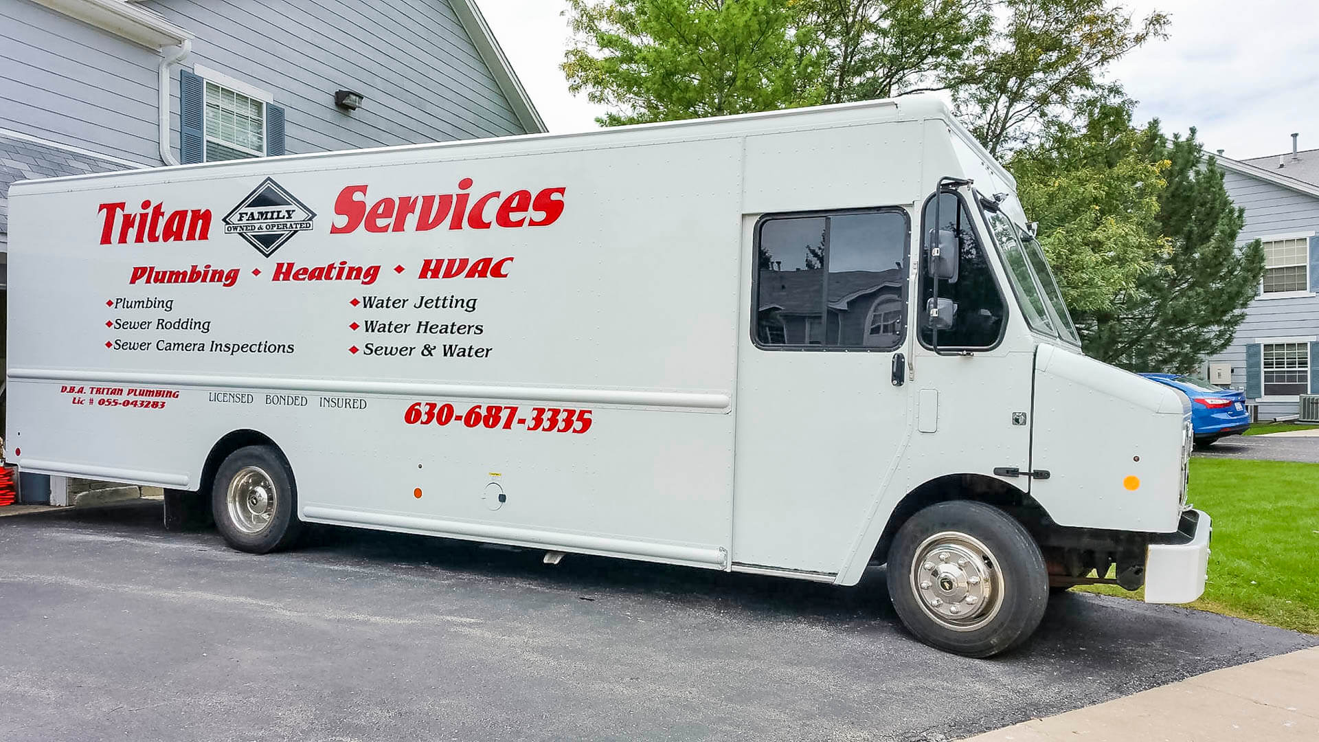 Rear view of Tritan Services HVAC box truck loaded with replacement equipment