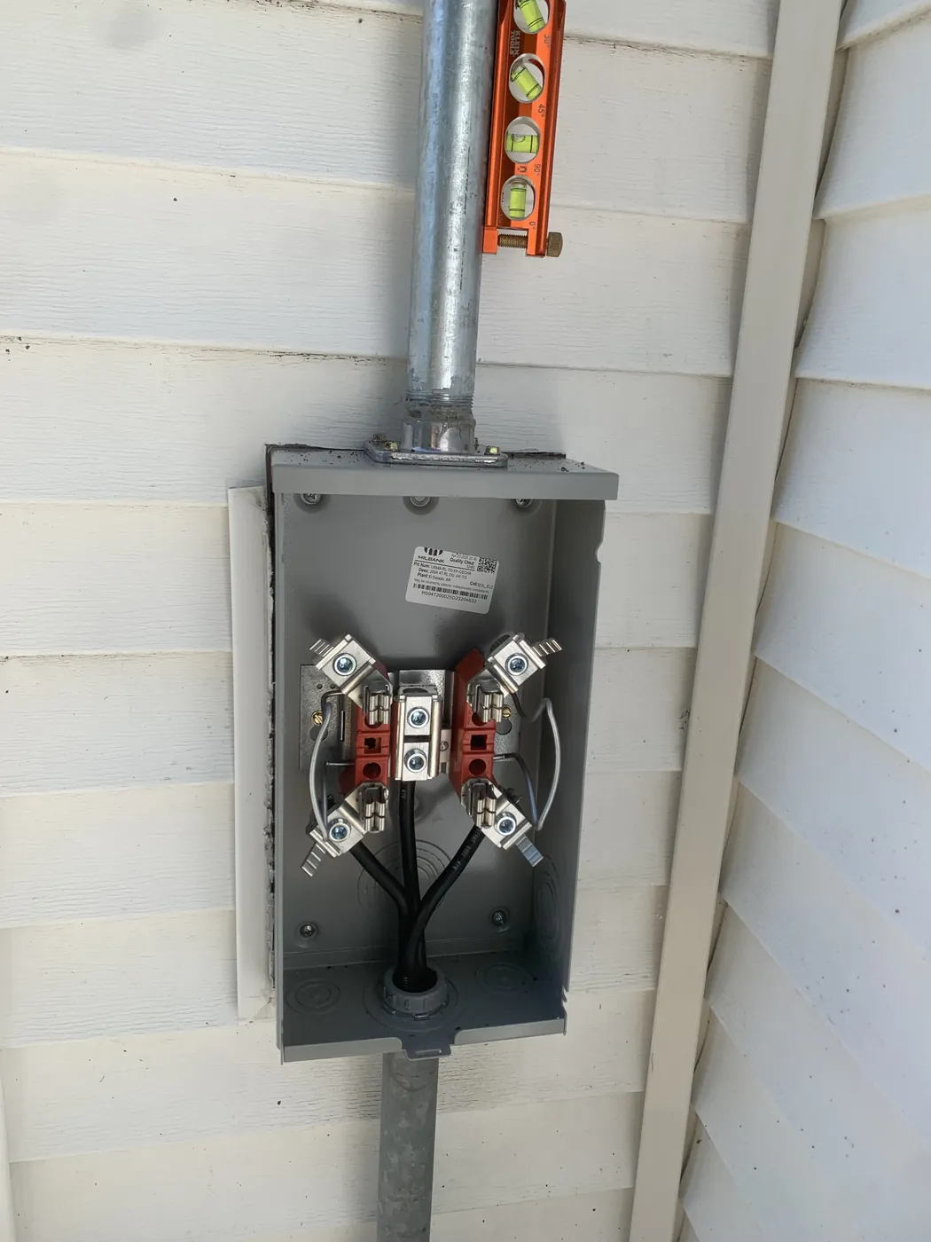 Exterior electrical meter and service disconnect on a customer home
