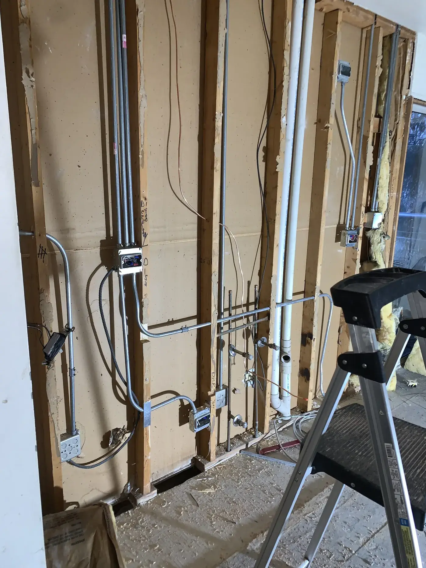 Electrical rough-in with multiple circuits exposed during a customer remodel