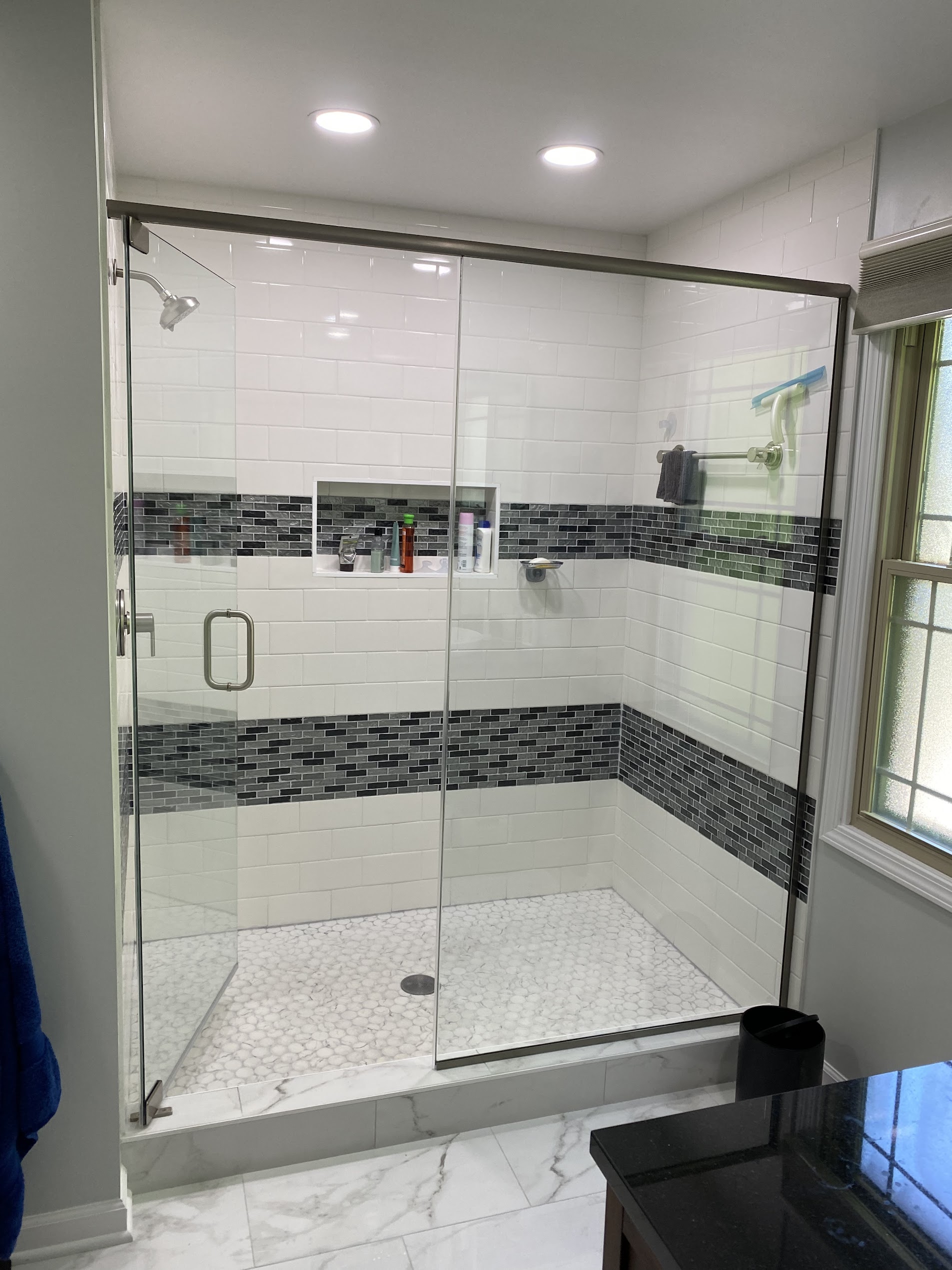 Glass walk-in tile shower installed by Tritan Services